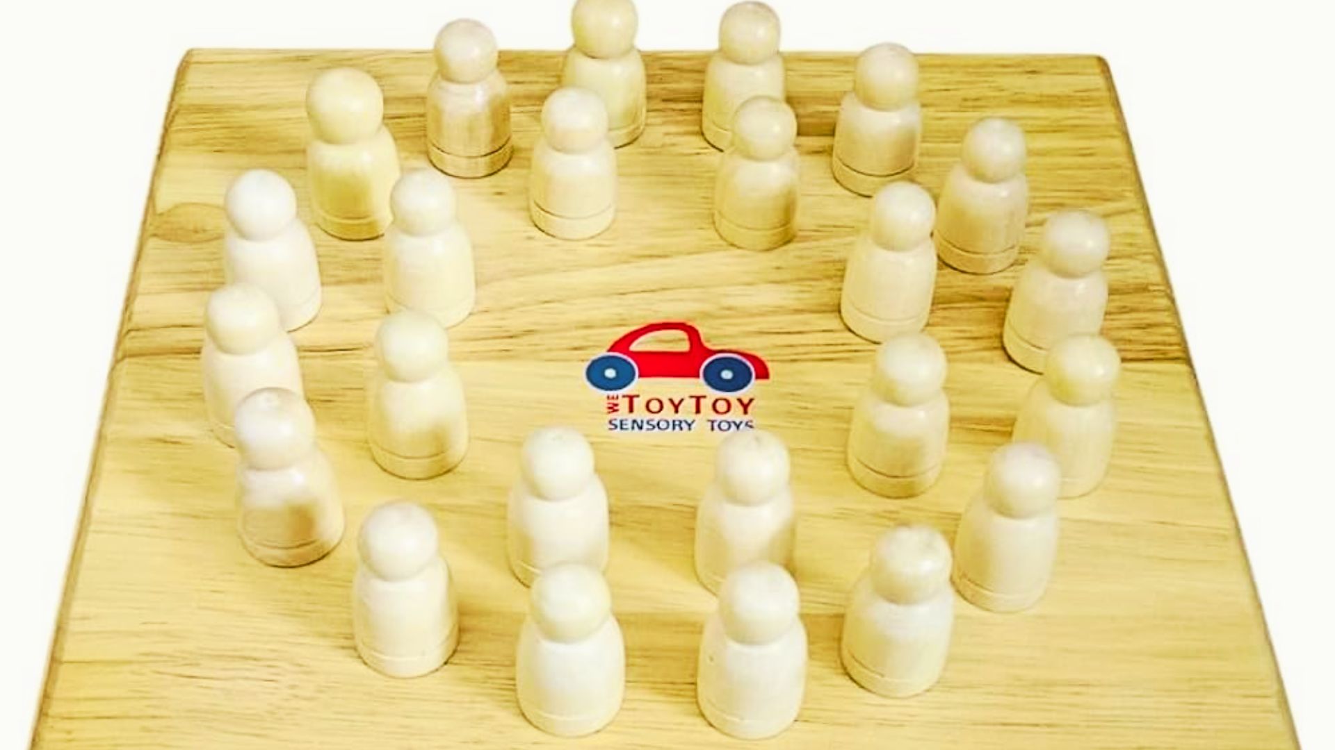 A wooden board displaying several wooden figures arranged in a playful manner.