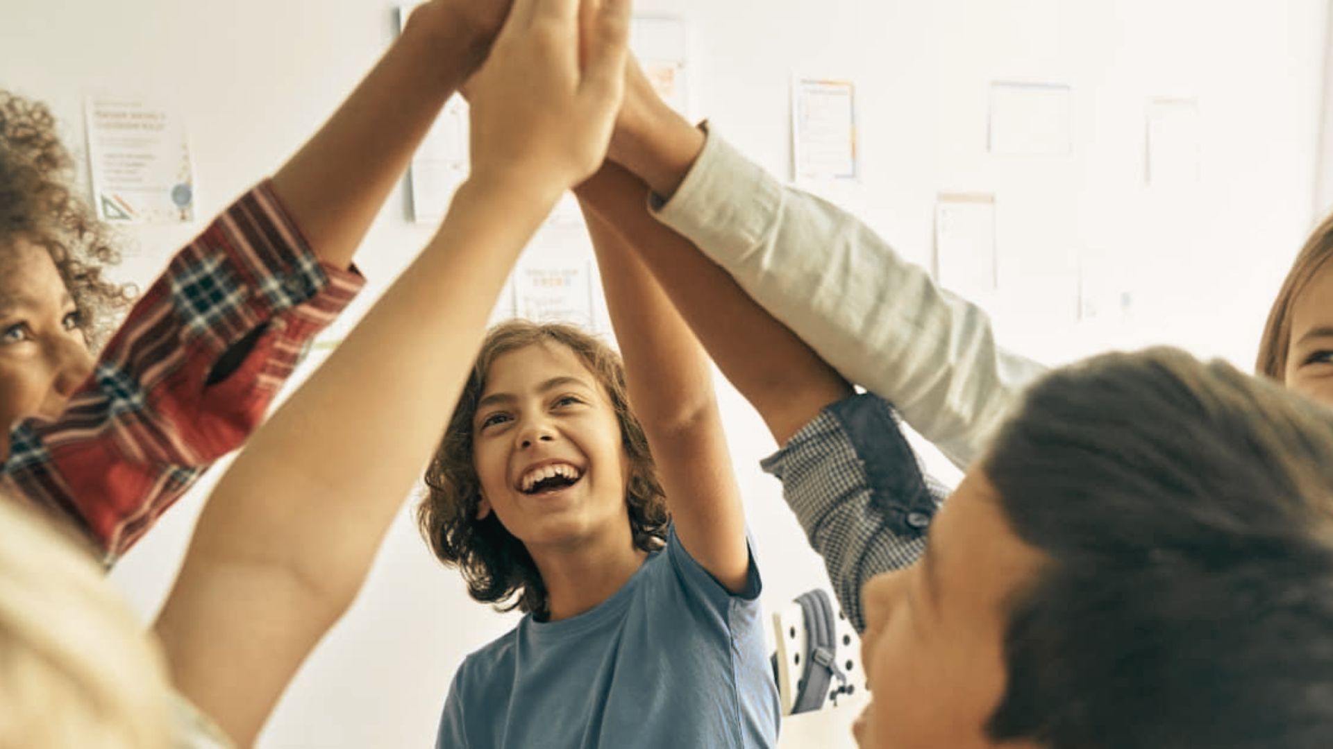 A diverse group of children holding hands, symbolizing togetherness and joy.