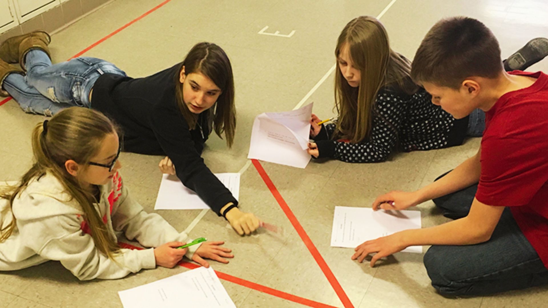 Students collaborating on a math problem, focused on solving challenges