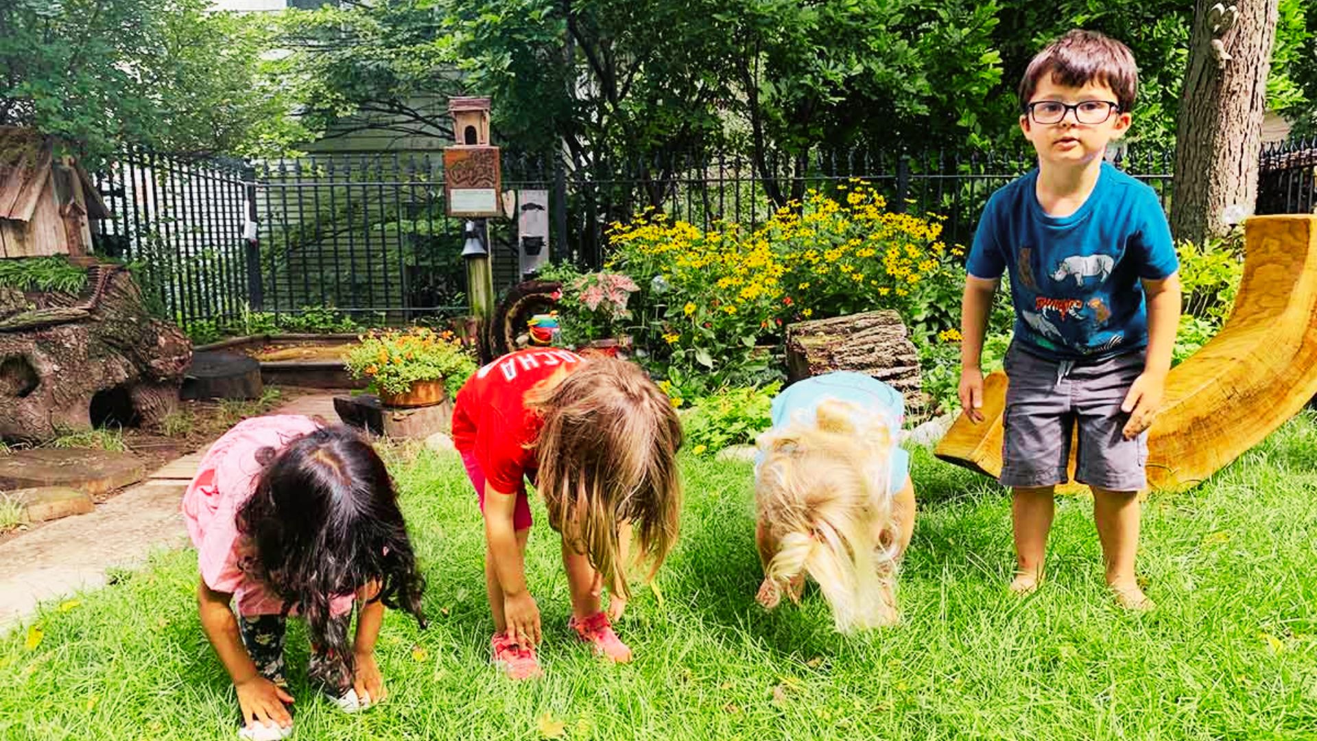 Children playing simon say joyfully in a yard , enjoying a sunny day outdoors.