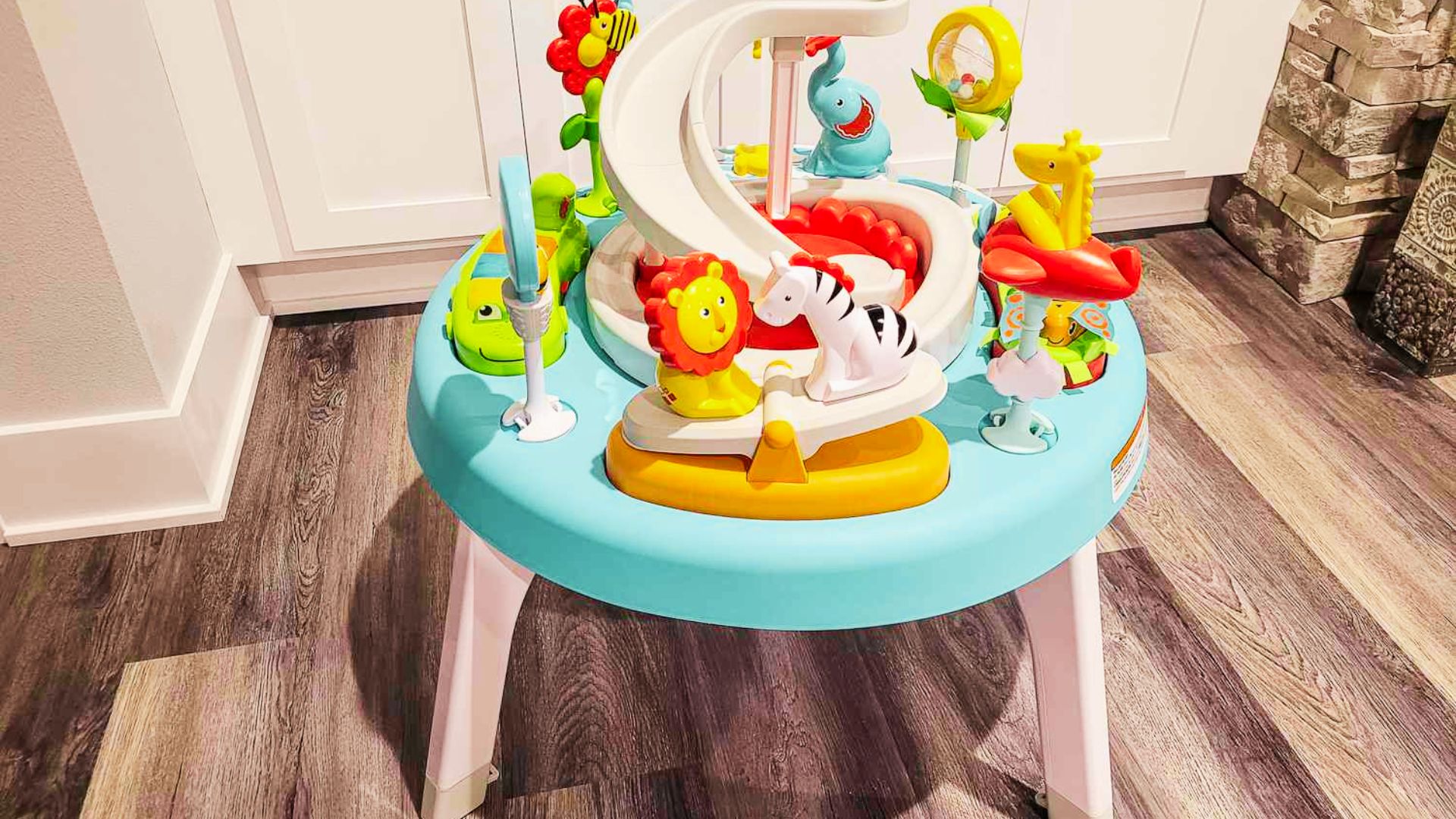 A baby toy table featuring an assortment of toys, such as rattles and stacking blocks, encouraging early childhood development.