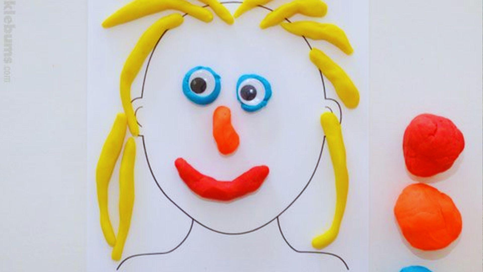 A colorful play dough face of a child, featuring bright eyes, a smiling mouth, and textured hair.