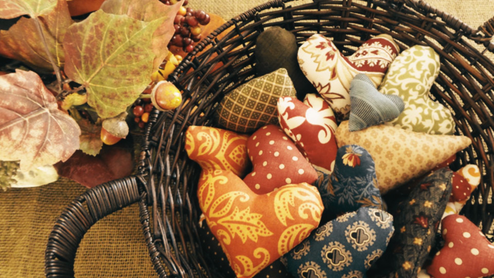 A woven basket filled with assorted fabric items in various colors and patterns.