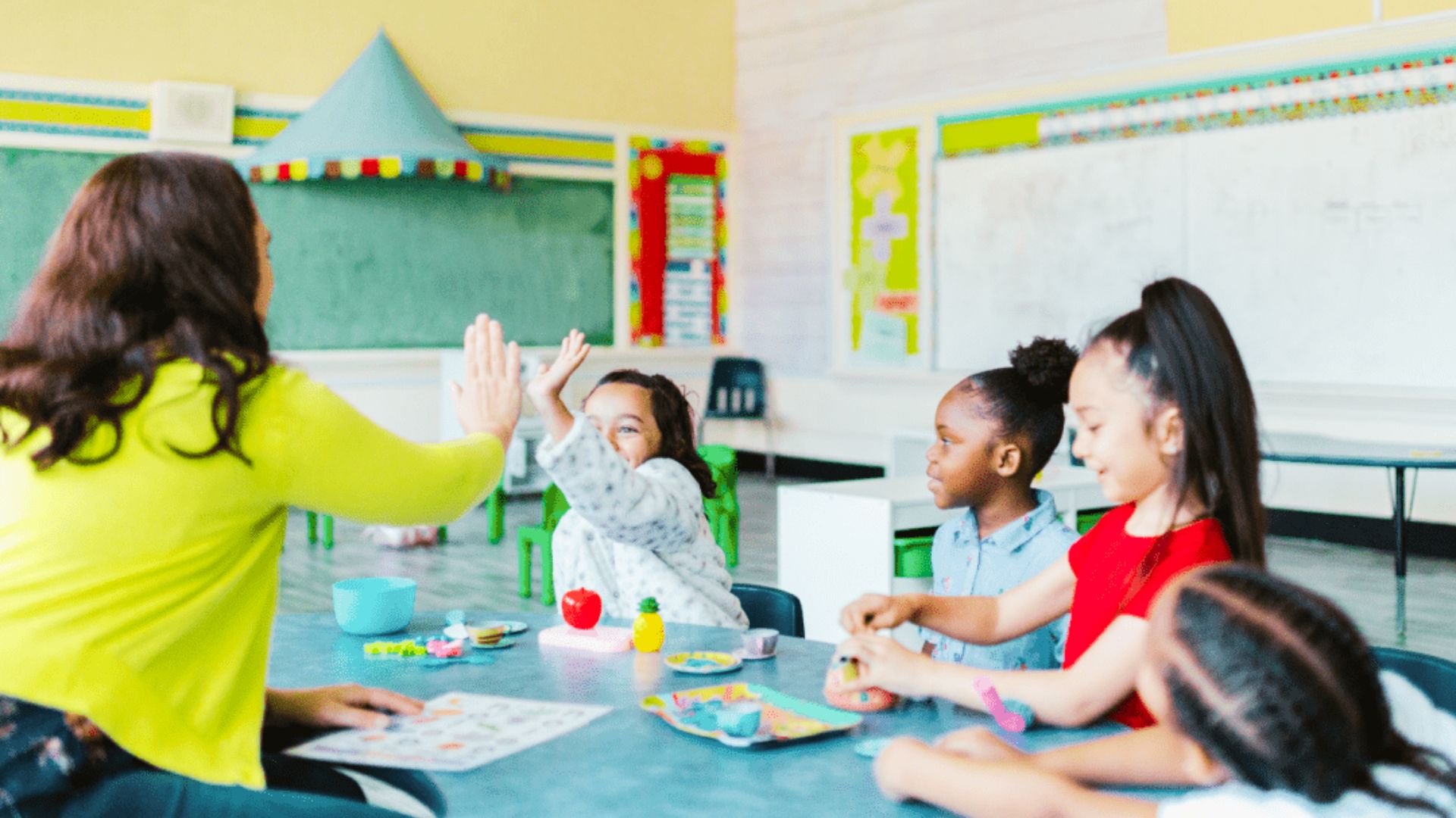 A teacher instructs a group of teenagers in a classroom setting, engaging them in problem-solving activities.