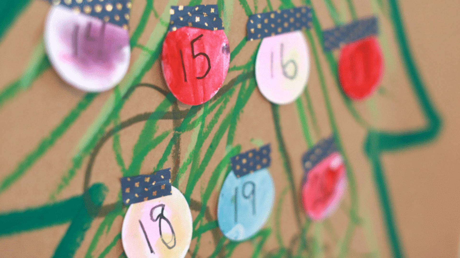 Close up of a handmade Advent calendar made from brown paper with green crayon scribbles.