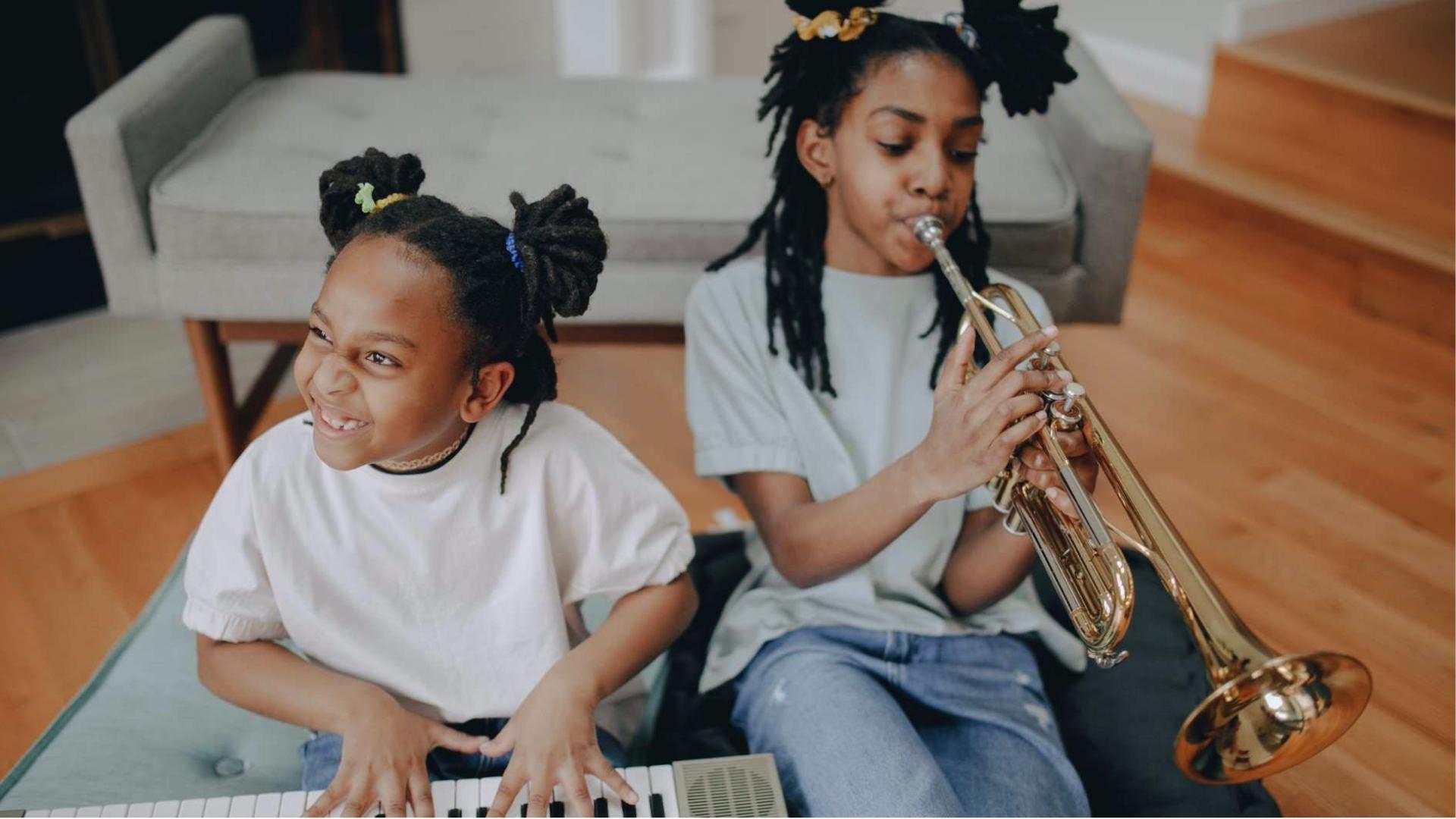 Two girls play music together, one on keyboard, one on trumpet, joyful session, Activities for Autistic Kids.