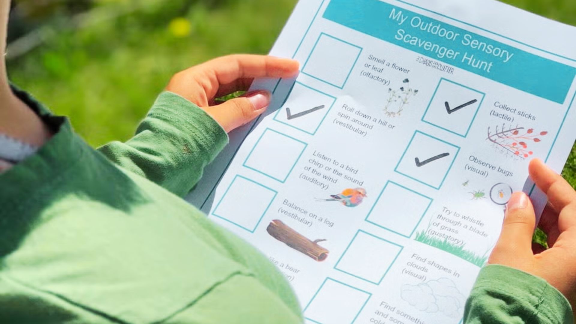 A child stands in the grass, holding a checklist.