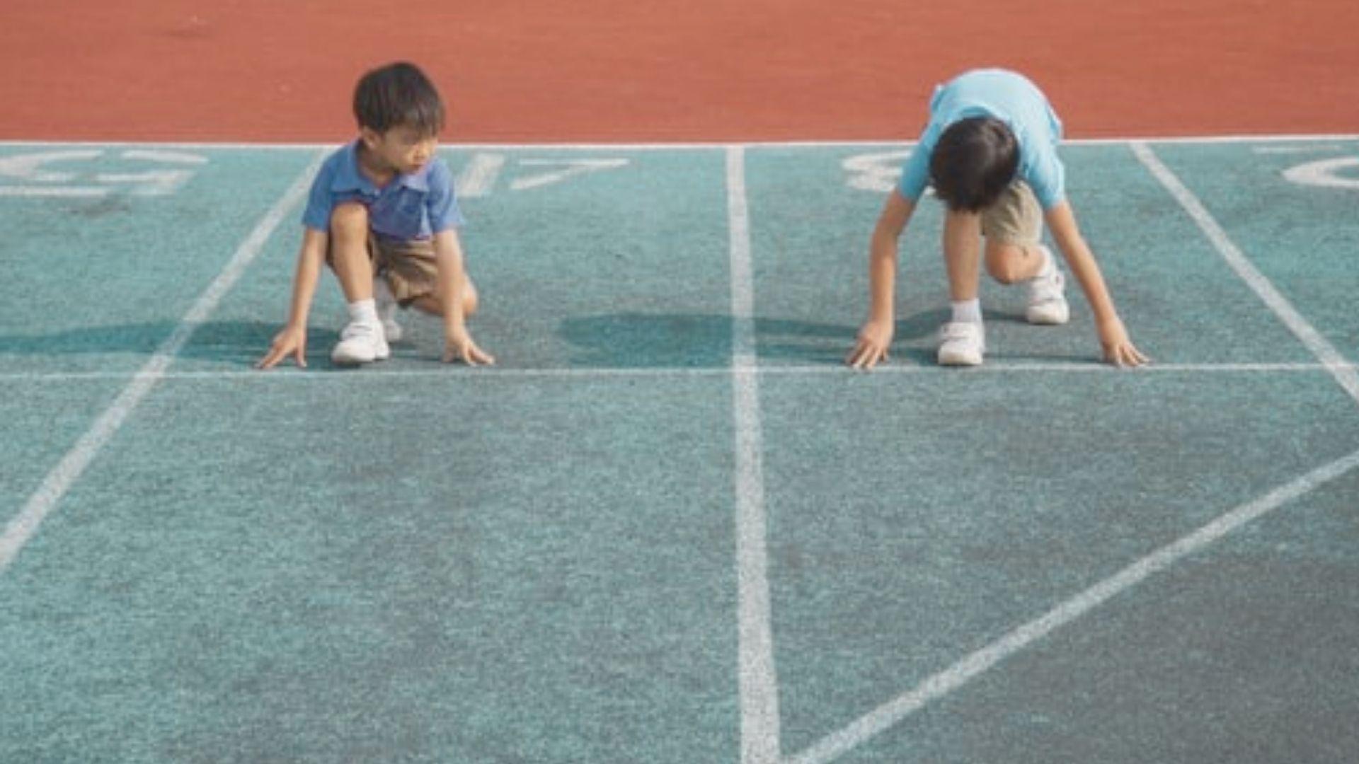 Kids racing while hopping and crawling like animals outdoors