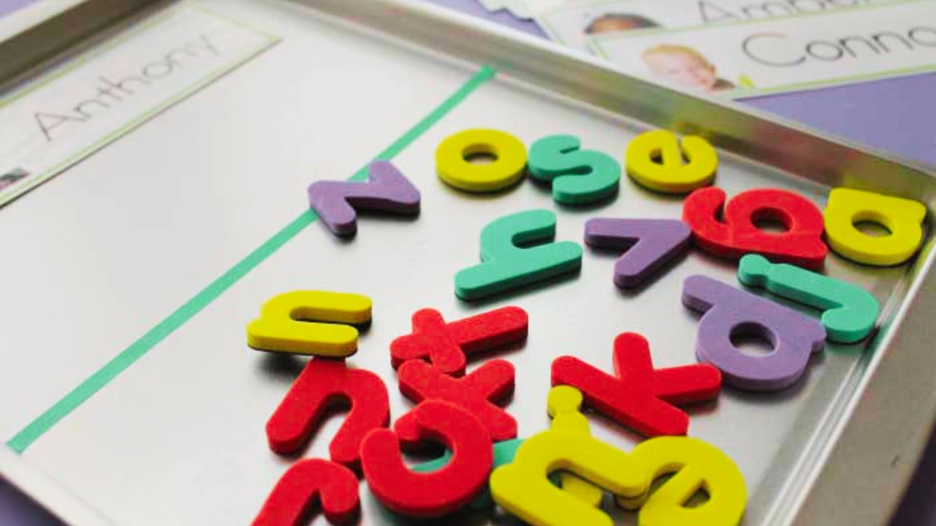 A tray filled with vibrant letters and numbers, showcasing a variety of colors and shapes for educational purposes.