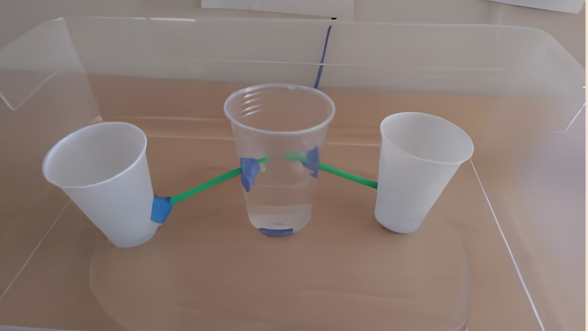 Homemade farm irrigation model using plastic cups, straws, and clay in a bin, a STEM water cycle activity for the classroom