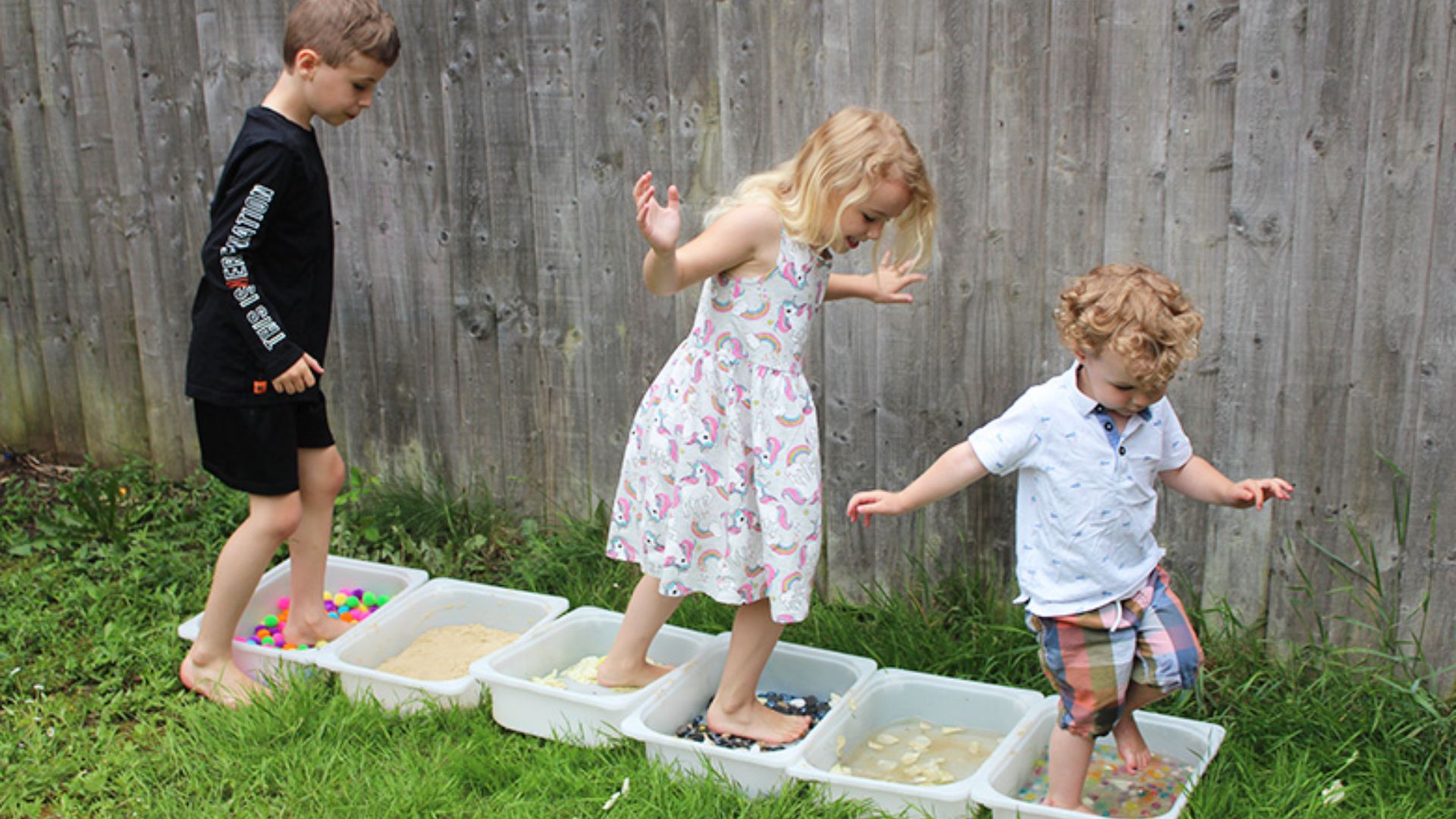 Sensory walk anger management activity for kids using bins filled with different textures to calm emotions.