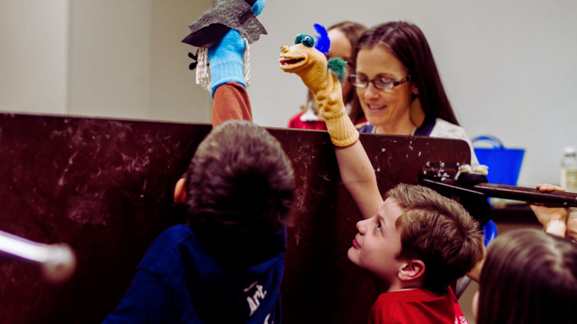 Children engaged in play with a colorful toy in a bright classroom setting.
