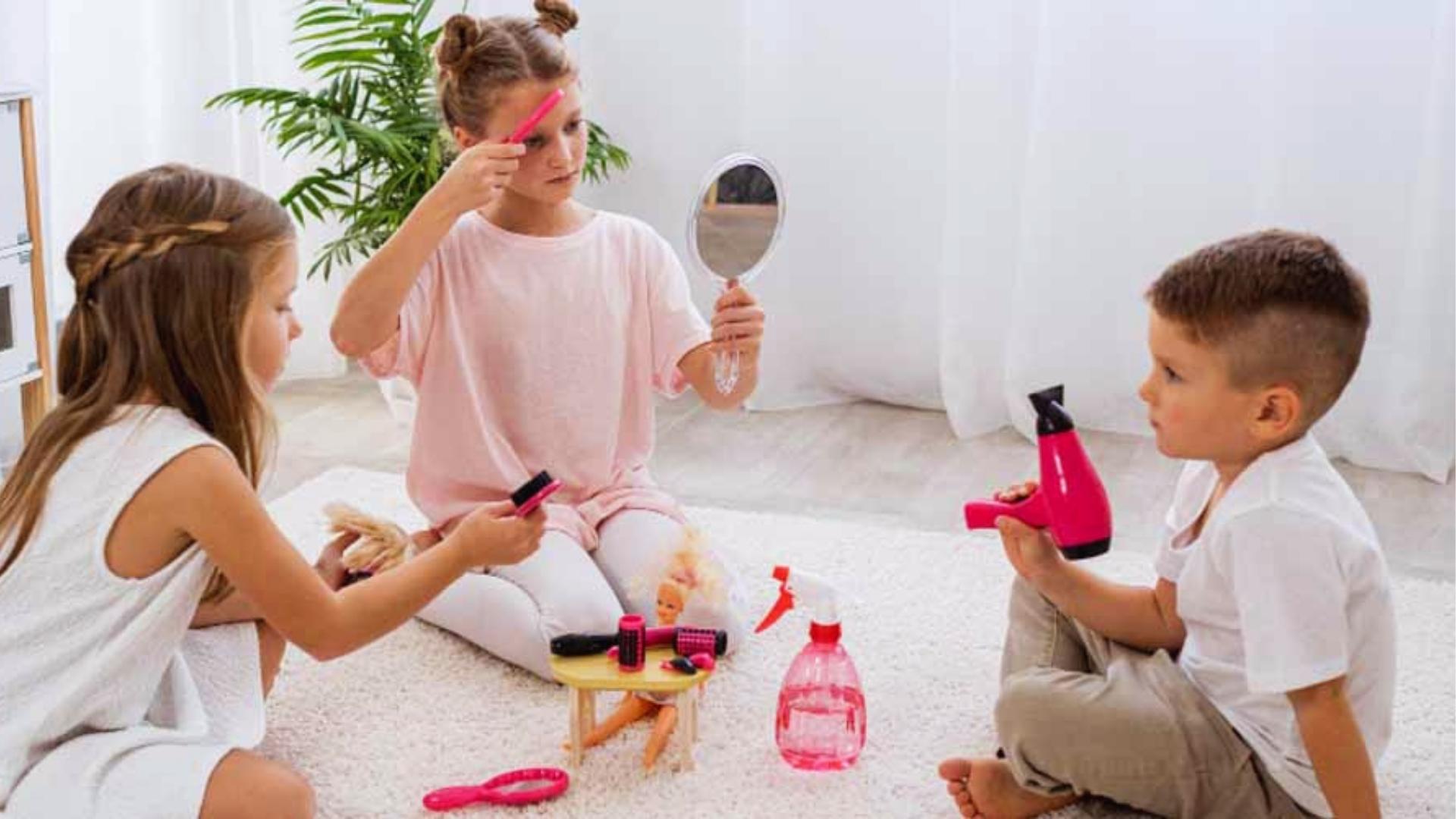 Three children play pretend salon with toy mirror, hairdryer, brushes, dolls, white rug, Activities for Autistic Kids.