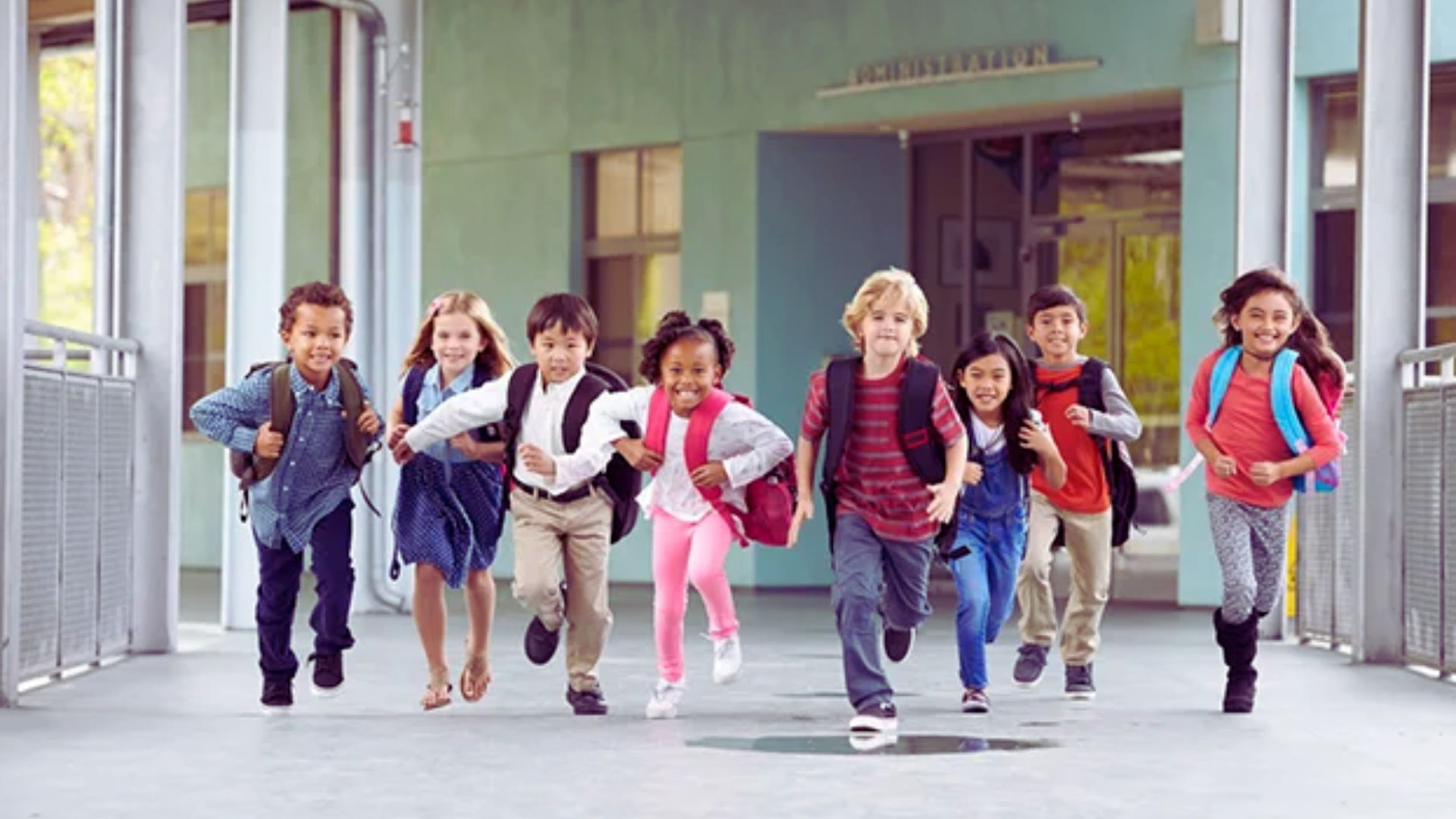 A group of children joyfully running down a brightly lit hallway, their laughter echoing off the walls.