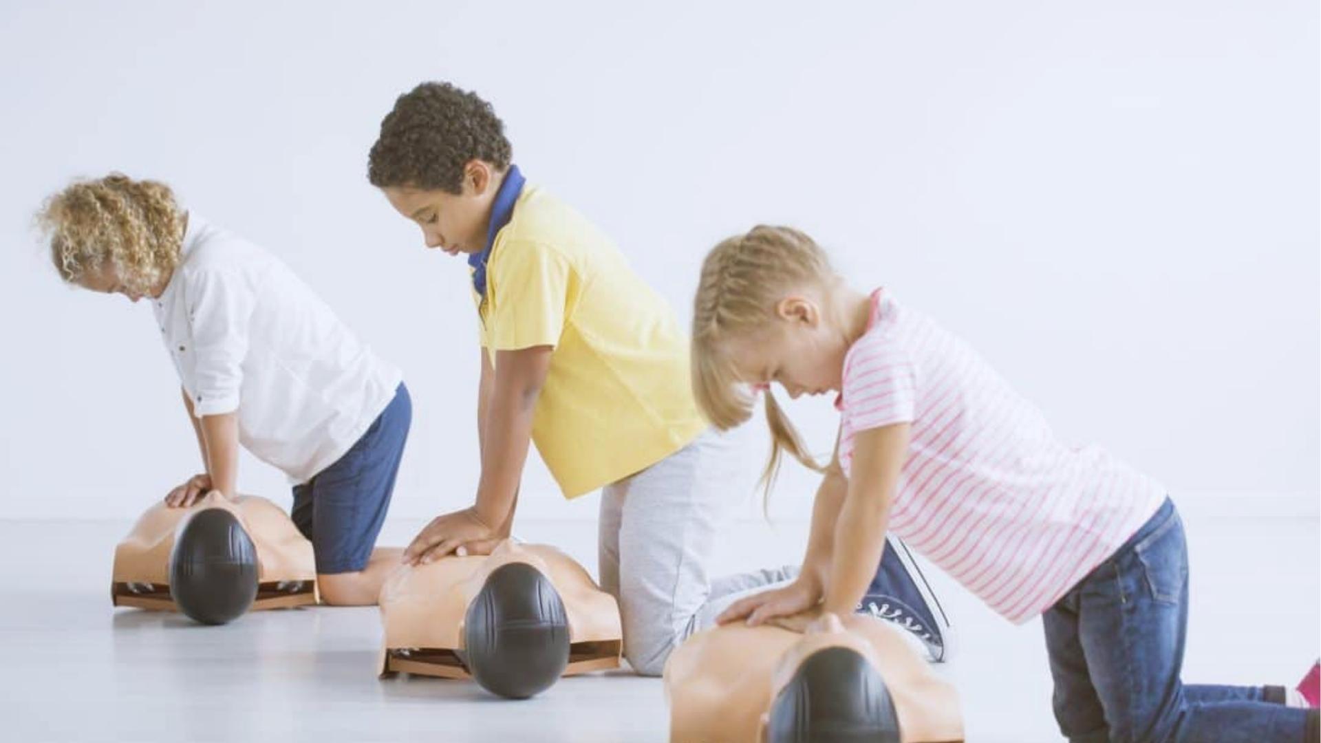 Child learning basic first aid skills with adult guidance while practicing basic first aid skills in a safe setting
