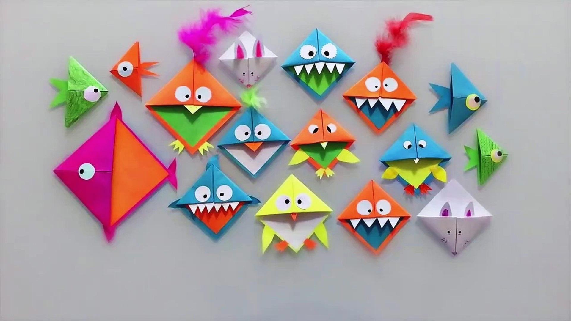 Collection of folded paper bookmarks shaped as monsters, fish, bunny, feathers, googly eyes.