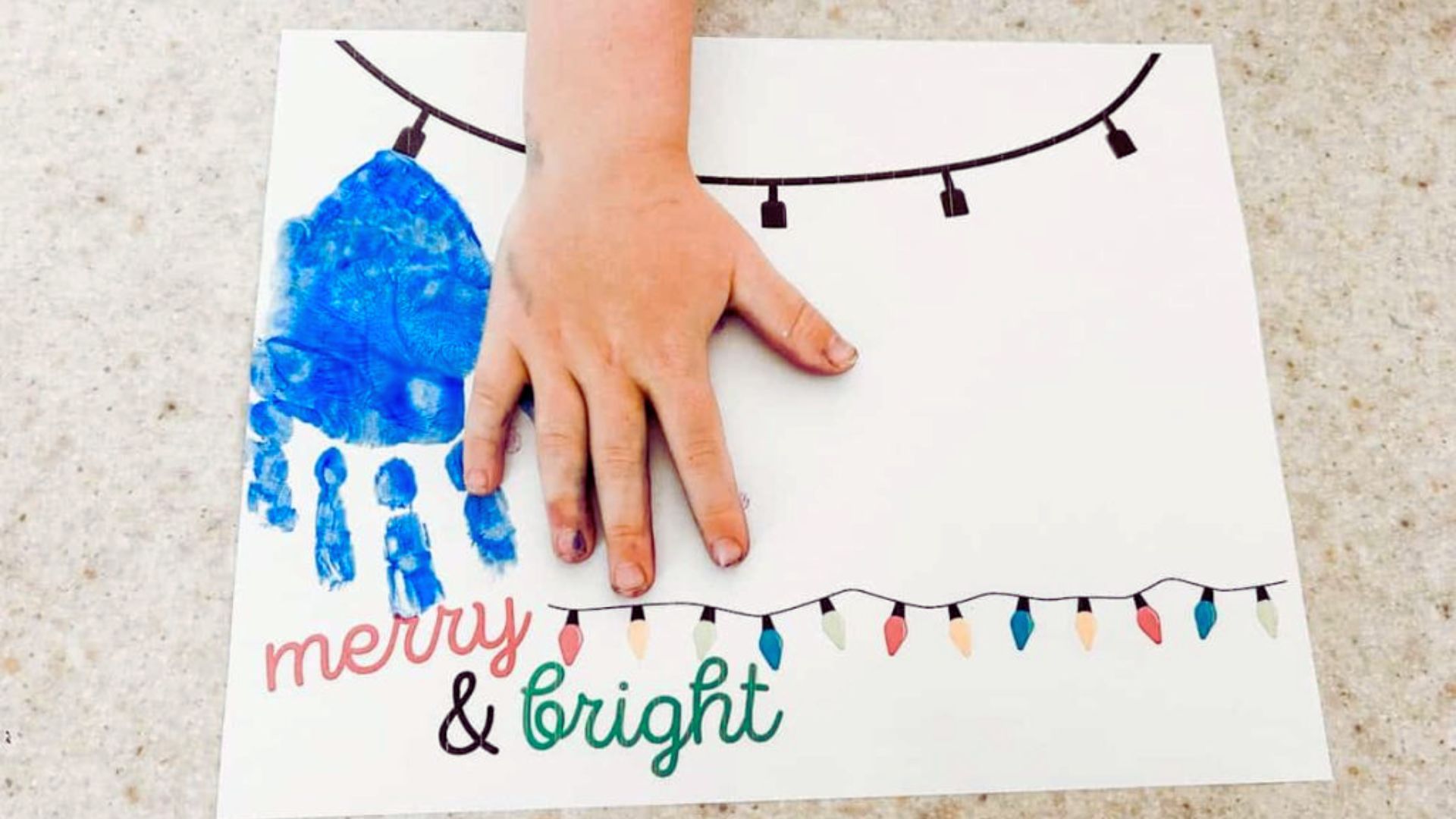 A Christmas card featuring a colorful handprint as the main design element.