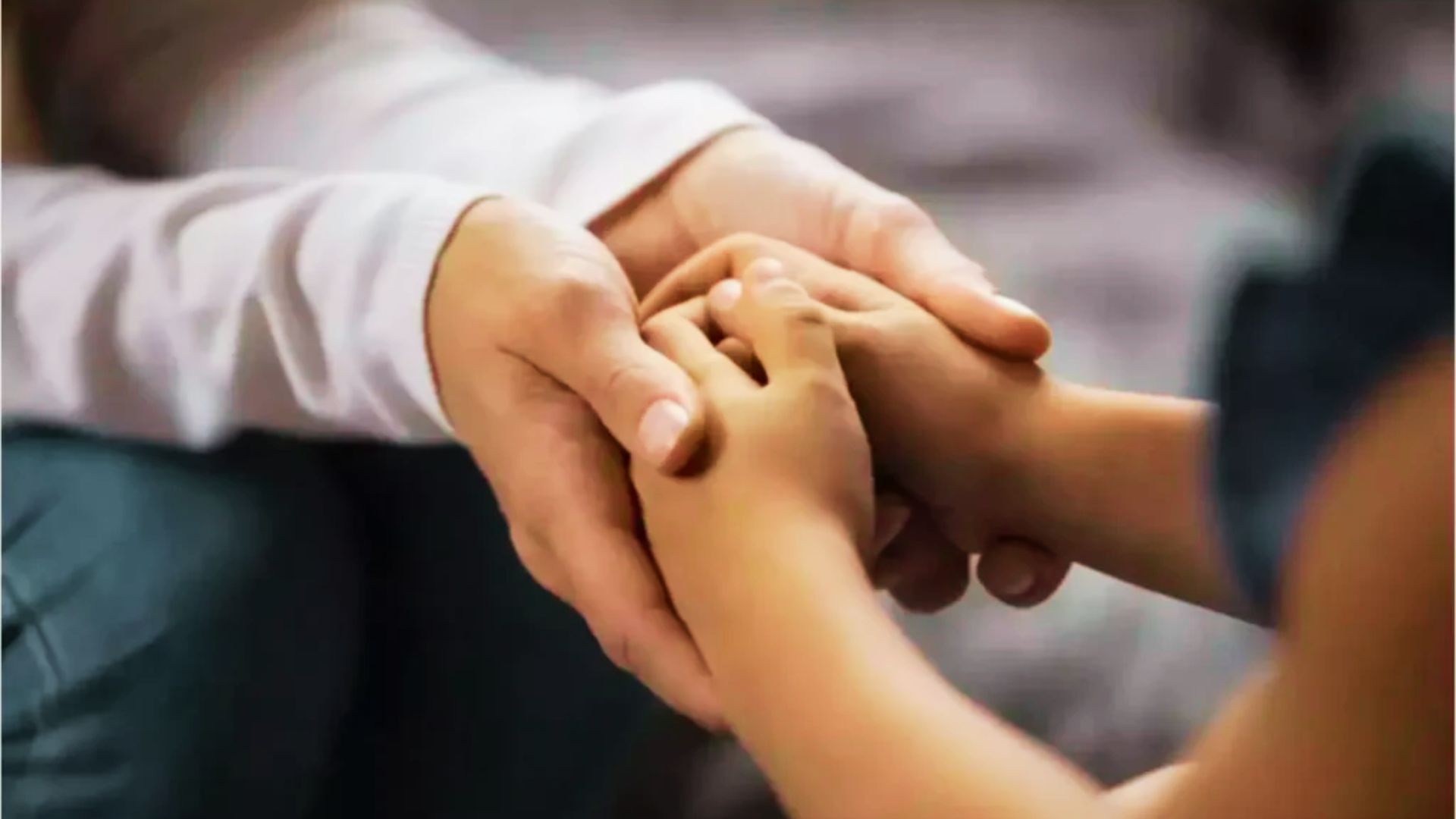 A child holds an adult's hand, symbolizing guidance and support in problem-solving activities for teens.