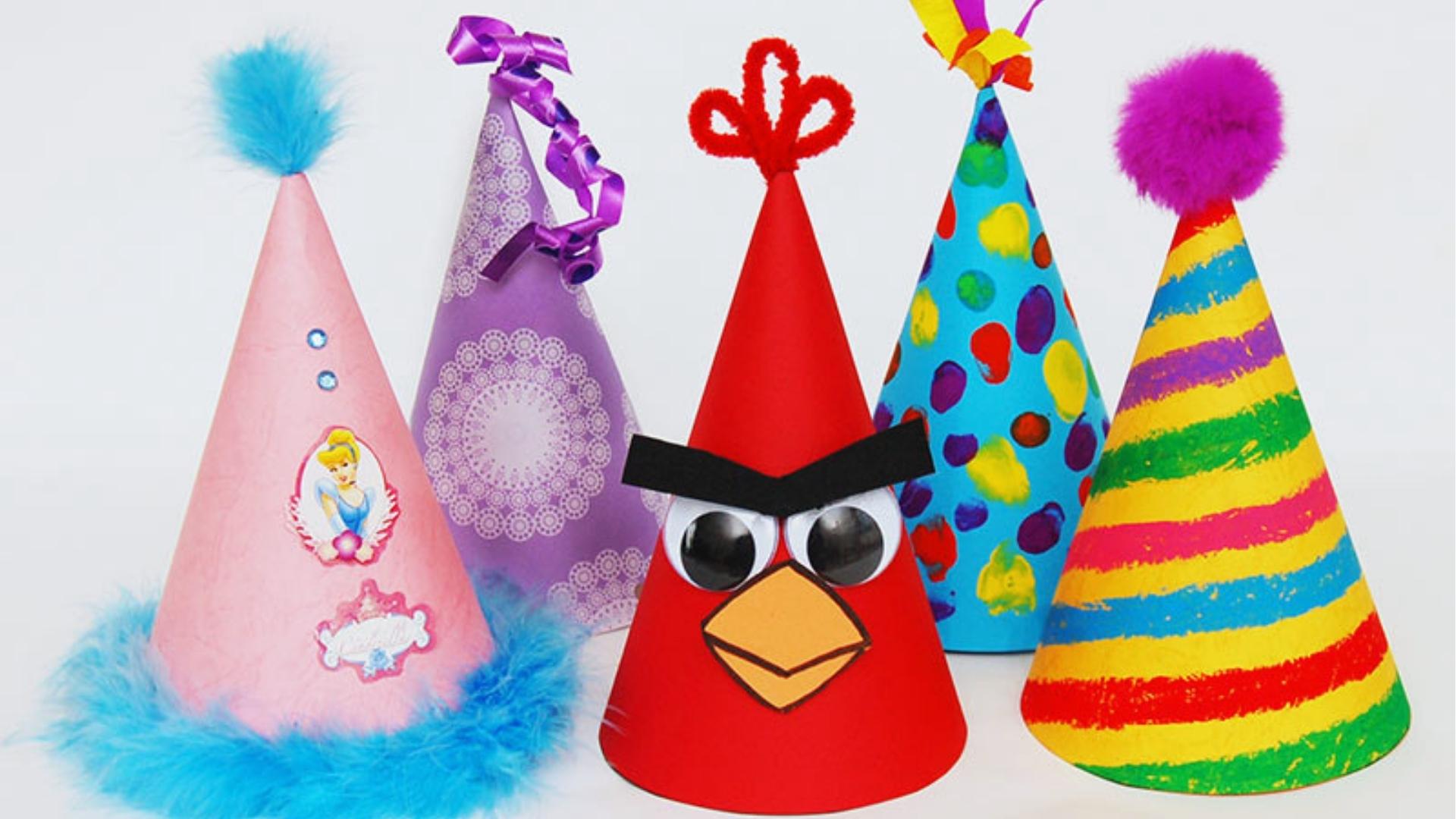 Five colorful DIY party hats with pom poms, stickers, Angry Bird design, feathers.
