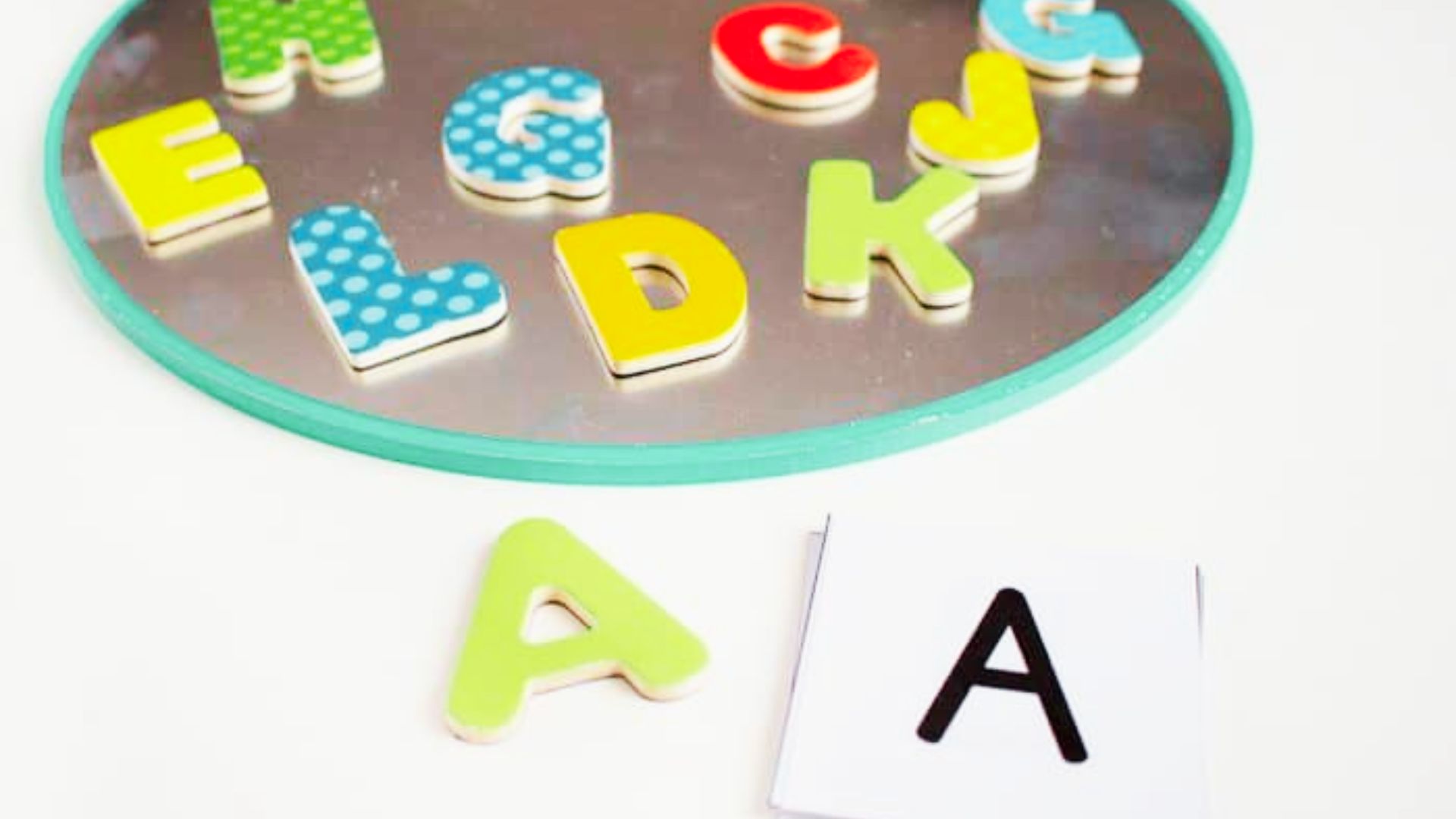 A mirror adorned with a mix of letters on its glass.