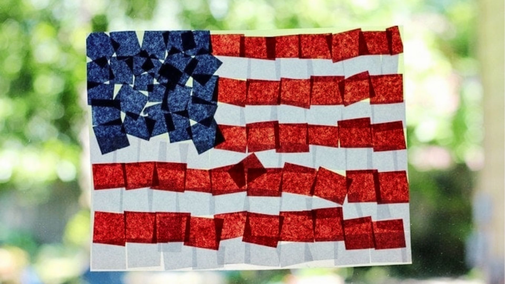 American flag suncatcher made from red and blue tissue paper squares stuck to clear contact paper.