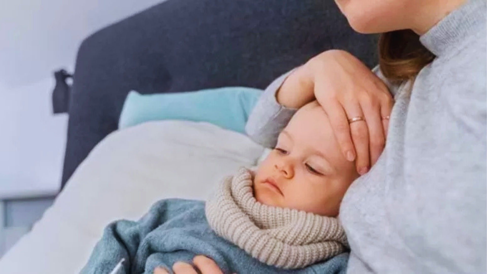Mother comforting feverish baby with hand on forehead, a typical scene when toddler fever strikes at night but eases.