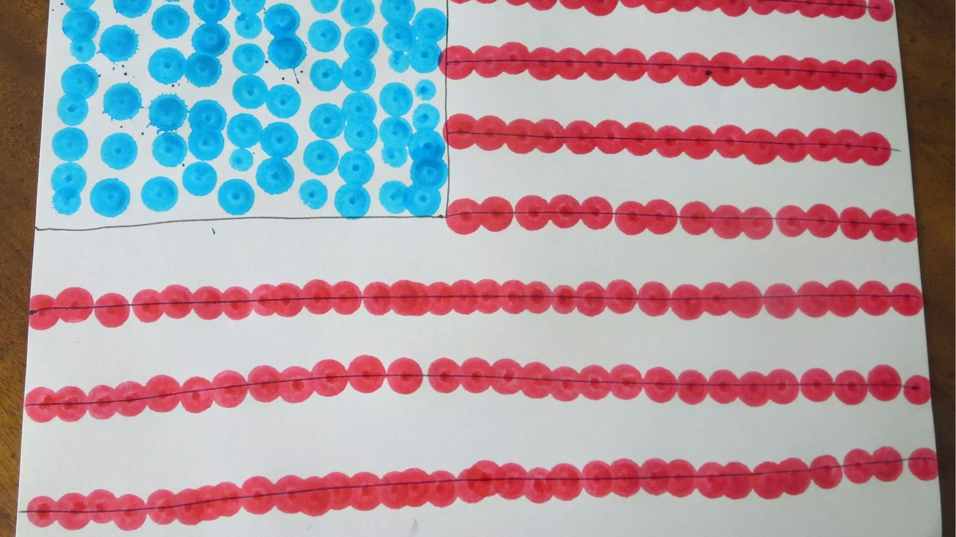 American flag made from blue and red dot marker prints on white paper with hand-drawn lines.