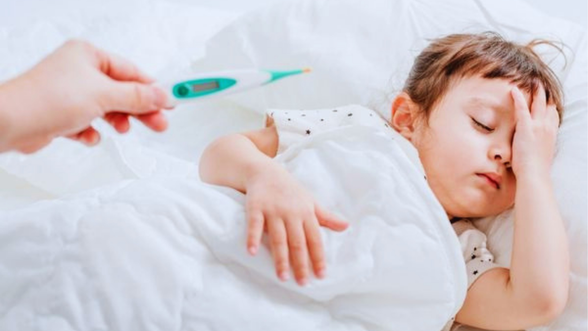Toddler sleeping while parent checks temperature with digital thermometer, explaining why fevers feel worse at night for kids.